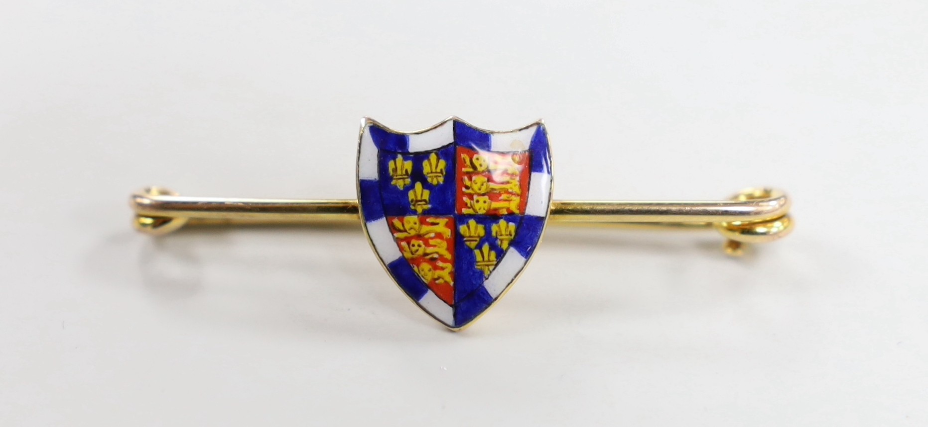 An early 20th century 9ct and polychrome enamel shield bar brooch, depicting the Royal Arms of England, 41mm, gross weight 2.9 grams.